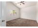 Bright bedroom features carpet flooring, window with natural light, and a ceiling fan at 2433 W Hayden Peak Dr, San Tan Valley, AZ 85144