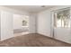 A beautiful bedroom features a large window, carpet flooring, and french doors at 2433 W Hayden Peak Dr, San Tan Valley, AZ 85144