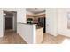 Charming kitchen with stainless steel fridge, granite counters, and neutral cabinets at 2433 W Hayden Peak Dr, San Tan Valley, AZ 85144