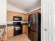 Updated kitchen featuring a stainless steel refrigerator and black appliances at 2433 W Hayden Peak Dr, San Tan Valley, AZ 85144