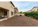 Backyard with patio, rock landscaping, privacy wall, and a view of neighboring houses at 2533 W Cordia Ln, Phoenix, AZ 85085