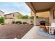 Covered patio and private backyard with neutral rock landscaping and privacy wall at 2533 W Cordia Ln, Phoenix, AZ 85085