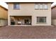 Back of house with covered patio and neutral rock landscaping with privacy wall at 2533 W Cordia Ln, Phoenix, AZ 85085