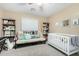 Neutral bedroom with a ceiling fan, a day bed, a crib, shelving, and plush carpet at 2533 W Cordia Ln, Phoenix, AZ 85085