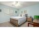 Bedroom with a light blue paint, a wooden bedframe, and a ceiling fan at 2533 W Cordia Ln, Phoenix, AZ 85085