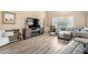 Comfortable living room with wood laminate flooring, a decorative clock, and stylish furniture at 2533 W Cordia Ln, Phoenix, AZ 85085