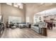Open-concept living area filled with natural light and featuring wood laminate flooring at 2533 W Cordia Ln, Phoenix, AZ 85085