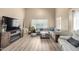 Spacious living room featuring wood laminate flooring, ample seating, and lots of natural light at 2533 W Cordia Ln, Phoenix, AZ 85085