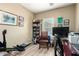 Bright office featuring wood-look floors, neutral walls, a desk, shelving, and a large window at 2533 W Cordia Ln, Phoenix, AZ 85085