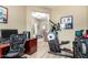Bright office area with hard surface floors, a desk, exercise equipment, and a view into another room at 2533 W Cordia Ln, Phoenix, AZ 85085