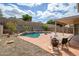 Enjoy this backyard oasis with a refreshing pool, rock features, lush landscaping and patio at 25825 N 65Th Ave, Phoenix, AZ 85083
