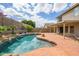 View of the refreshing pool, patio and lush landscaping in this inviting backyard oasis at 25825 N 65Th Ave, Phoenix, AZ 85083