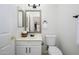 Clean, well-maintained half bath with a classic vanity, mirror, and neutral color palette at 25825 N 65Th Ave, Phoenix, AZ 85083