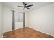 Bedroom featuring hardwood floors, ceiling fan, and large window at 25825 N 65Th Ave, Phoenix, AZ 85083