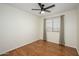 Bright bedroom featuring hardwood floors, ceiling fan, and large window at 25825 N 65Th Ave, Phoenix, AZ 85083