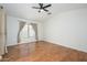 Bright bedroom featuring hardwood floors, ceiling fan, and large window with curtains at 25825 N 65Th Ave, Phoenix, AZ 85083