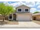 Charming two-story home with a well-manicured front yard, a two-car garage, and neutral paint colors at 25825 N 65Th Ave, Phoenix, AZ 85083