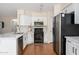 Modern kitchen with stainless steel appliances, white cabinets, and a stylish breakfast bar at 25825 N 65Th Ave, Phoenix, AZ 85083