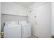 Clean and functional laundry room features a washer, dryer, shelving and access to the exterior at 25825 N 65Th Ave, Phoenix, AZ 85083