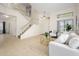 Bright living room with tiled floors, staircase, and plenty of natural light for a warm and inviting atmosphere at 25825 N 65Th Ave, Phoenix, AZ 85083