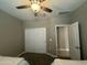 Spacious bedroom with a ceiling fan, closet, and neutral-colored walls at 30395 W Mitchell Ave, Buckeye, AZ 85396