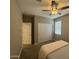 Cozy bedroom with neutral tones, ceiling fan, and closet with sliding doors at 30395 W Mitchell Ave, Buckeye, AZ 85396