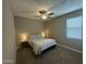 Comfortable bedroom featuring bedside lamps, a window, and neutral decor at 30395 W Mitchell Ave, Buckeye, AZ 85396