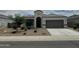 Charming single-story home featuring a two-car garage and desert landscaping at 30395 W Mitchell Ave, Buckeye, AZ 85396