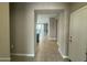 Hallway view with tile flooring leading to the open-concept living areas at 30395 W Mitchell Ave, Buckeye, AZ 85396