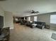 Spacious living room with tile floors, ceiling fan, and views of the kitchen area at 30395 W Mitchell Ave, Buckeye, AZ 85396