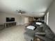 Spacious living room with tile floors, ceiling fan, and views of the kitchen area at 30395 W Mitchell Ave, Buckeye, AZ 85396