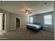 Main bedroom featuring carpet floors, a ceiling fan, and natural light at 30395 W Mitchell Ave, Buckeye, AZ 85396