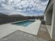 View of the backyard showcasing a pool, patio, and lush desert landscaping at 30395 W Mitchell Ave, Buckeye, AZ 85396