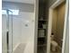 Bathroom shower with glass doors, storage shelving, and toilet room at 30395 W Mitchell Ave, Buckeye, AZ 85396