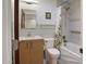 Modern bathroom with tile backsplash, white tub, shower, and sleek wooden vanity at 309 E Huntington Dr, Tempe, AZ 85282