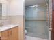 Modern bathroom featuring a glass shower, light wood vanity, and neutral color palette at 309 E Huntington Dr, Tempe, AZ 85282