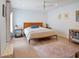 Comfortable bedroom with hardwood floors, ceiling fan, and a full sized bed frame with blue accents at 309 E Huntington Dr, Tempe, AZ 85282