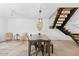 Dining room featuring modern table, seating, decorative accents, and staircase leading to upper level at 309 E Huntington Dr, Tempe, AZ 85282