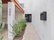 Modern home's inviting entrance features a black door and desert landscaping, offering a stylish welcome at 309 E Huntington Dr, Tempe, AZ 85282