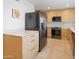 Modern kitchen featuring light wood cabinets, stainless steel appliances, and a sleek countertop at 309 E Huntington Dr, Tempe, AZ 85282