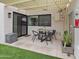 Enclosed patio features sleek furniture and is paved with light-colored tiles and bordered by artificial grass at 309 E Huntington Dr, Tempe, AZ 85282