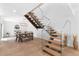 Modern staircase with wood treads and glass railing leads to upper level, adjacent dining area with seating at 309 E Huntington Dr, Tempe, AZ 85282