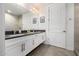 Bathroom features a double vanity, framed mirrors, a white cabinets, and neutral tiling throughout at 3131 N Central Ave # 6010, Phoenix, AZ 85012