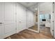 Hallway leading to a home office and a bathroom features hardwood floors and built in storage at 3131 N Central Ave # 6010, Phoenix, AZ 85012