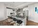 Modern kitchen with stainless steel appliances, a gray tile backsplash, and a spacious island with seating at 3131 N Central Ave # 6010, Phoenix, AZ 85012