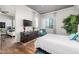 This spacious main bedroom features hardwood floors, large windows, a flat screen television, and stylish furnishings at 3131 N Central Ave # 6010, Phoenix, AZ 85012