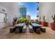 Outdoor patio area with modern concrete furniture, dining spaces, and lush potted cacti for a stylish retreat at 3131 N Central Ave # 6010, Phoenix, AZ 85012