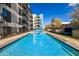 Long pool and modern architecture, perfect for swimming laps with greenery and lounge chairs for relaxation at 3131 N Central Ave # 6010, Phoenix, AZ 85012