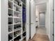 Bright walk-in closet featuring hardwood floors, a storage unit for shoes, and a doorway to the main bathroom at 3131 N Central Ave # 6010, Phoenix, AZ 85012