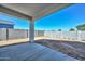 View of the backyard with concrete patio and block wall at 32017 N Redding St, Wittmann, AZ 85361